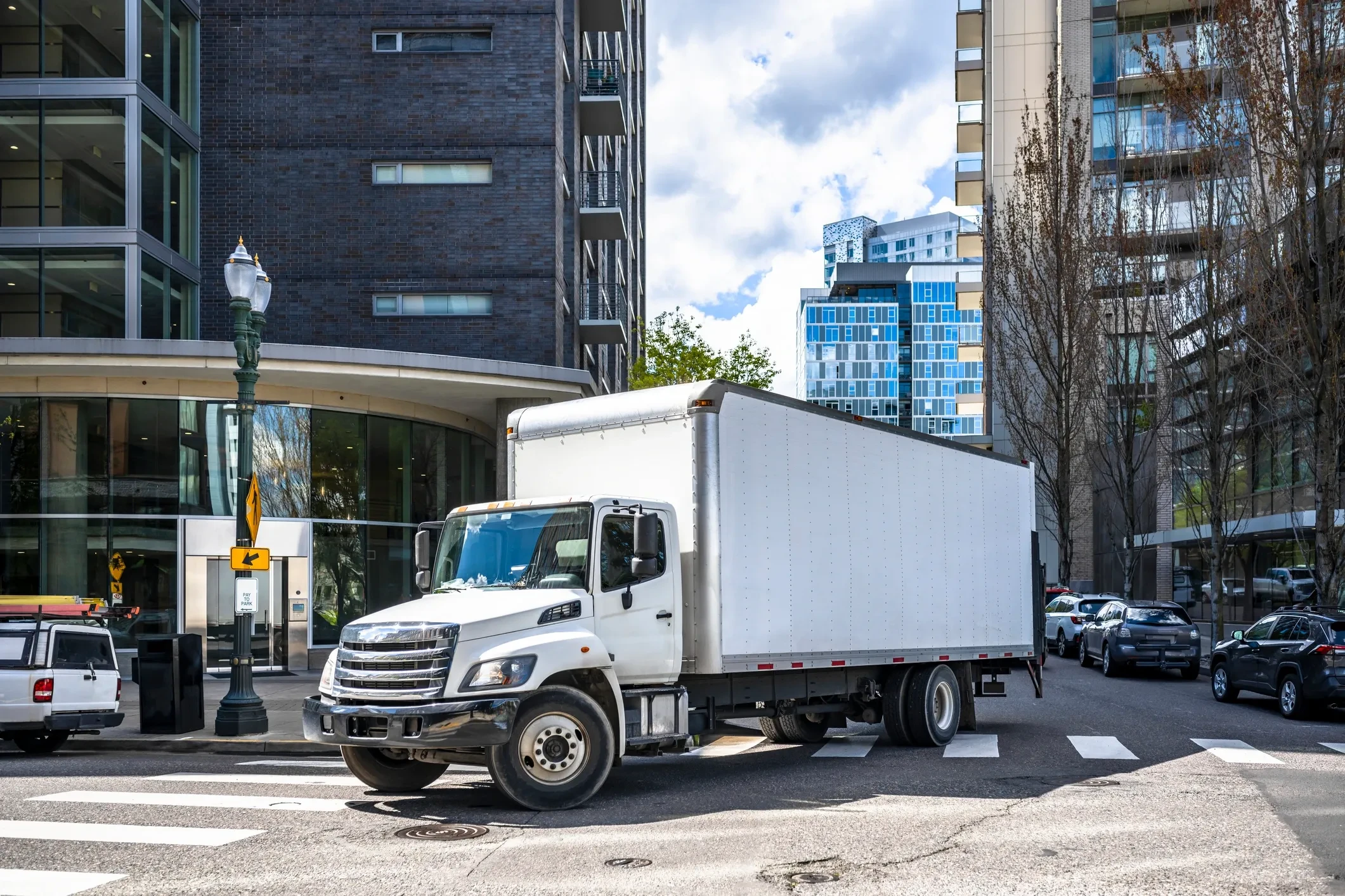 Ascora Logistics box truck on urban city street