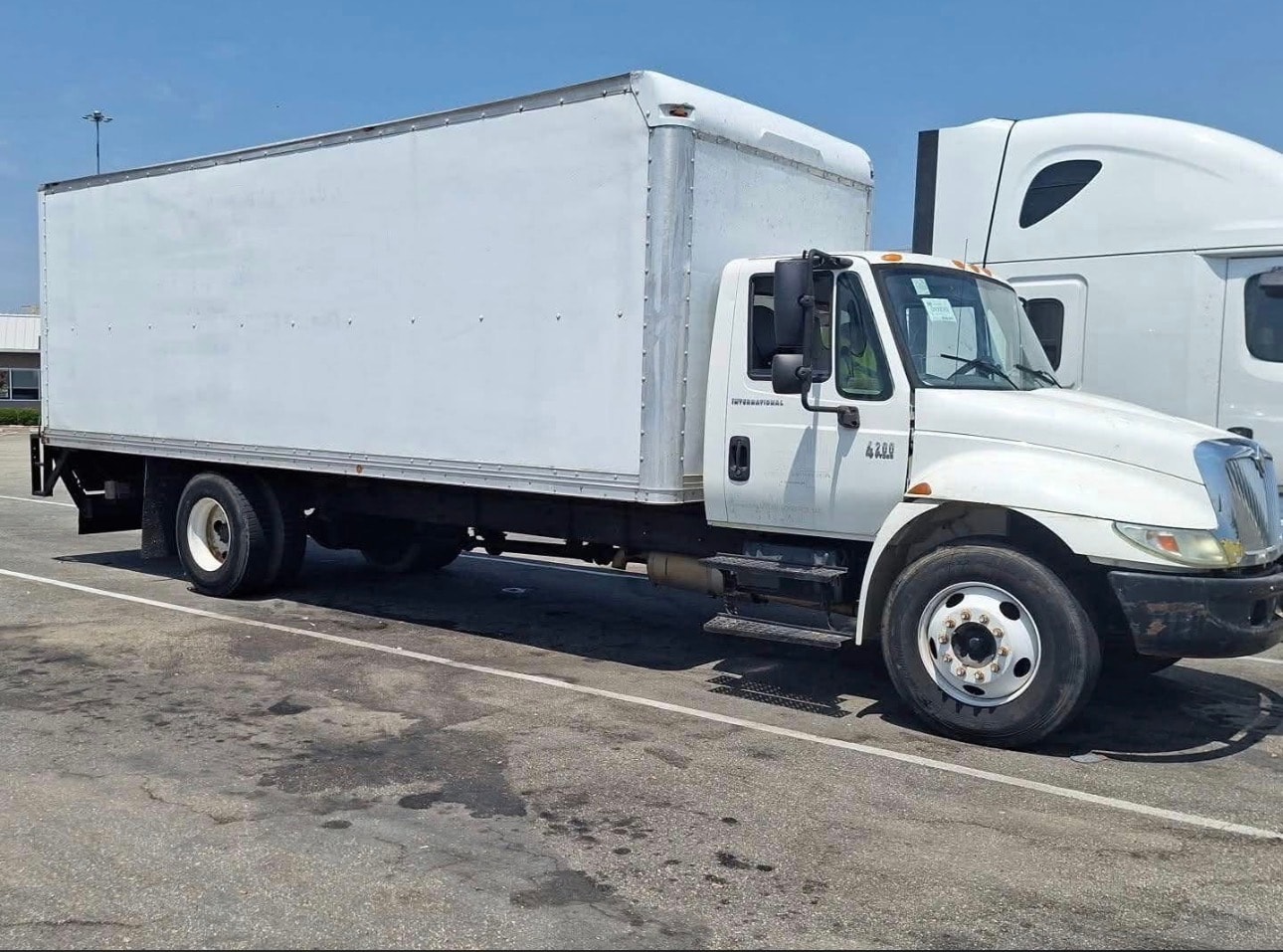 Ascora Logistics white box truck parked